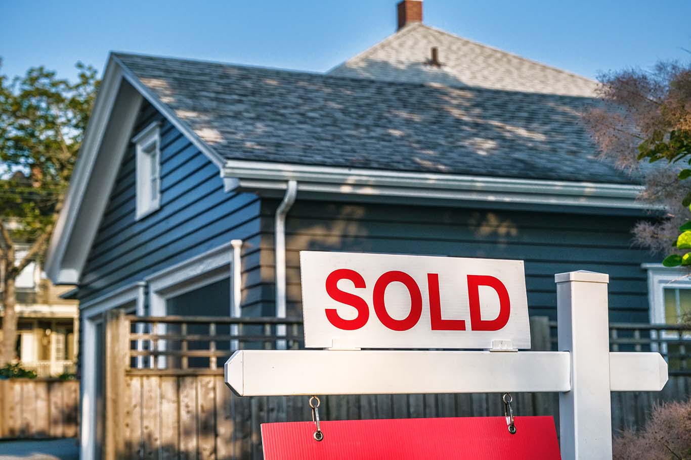 Sold Sign in front of a house.